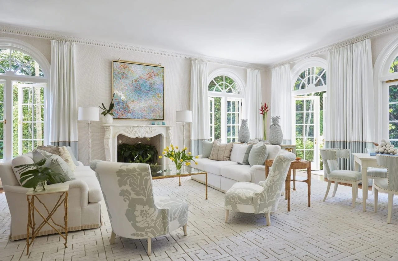 Bright Palm Beach living room with arched windows and white sofas