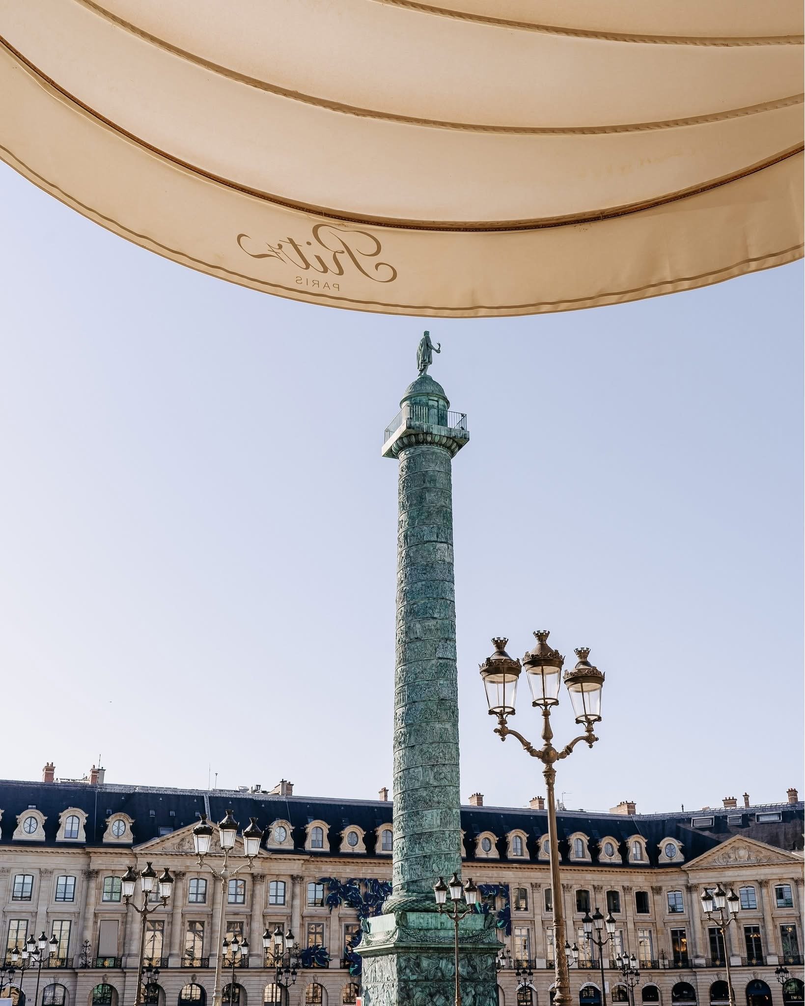 Standing under the Ritz Paris entrance with view onto Place Vendǒme.