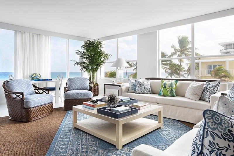 Palm Beach oceanfront neutral living room with white sofas and blue coastal decor