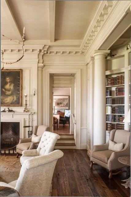European-inspired Palm Beach library living room with paneled fireplace