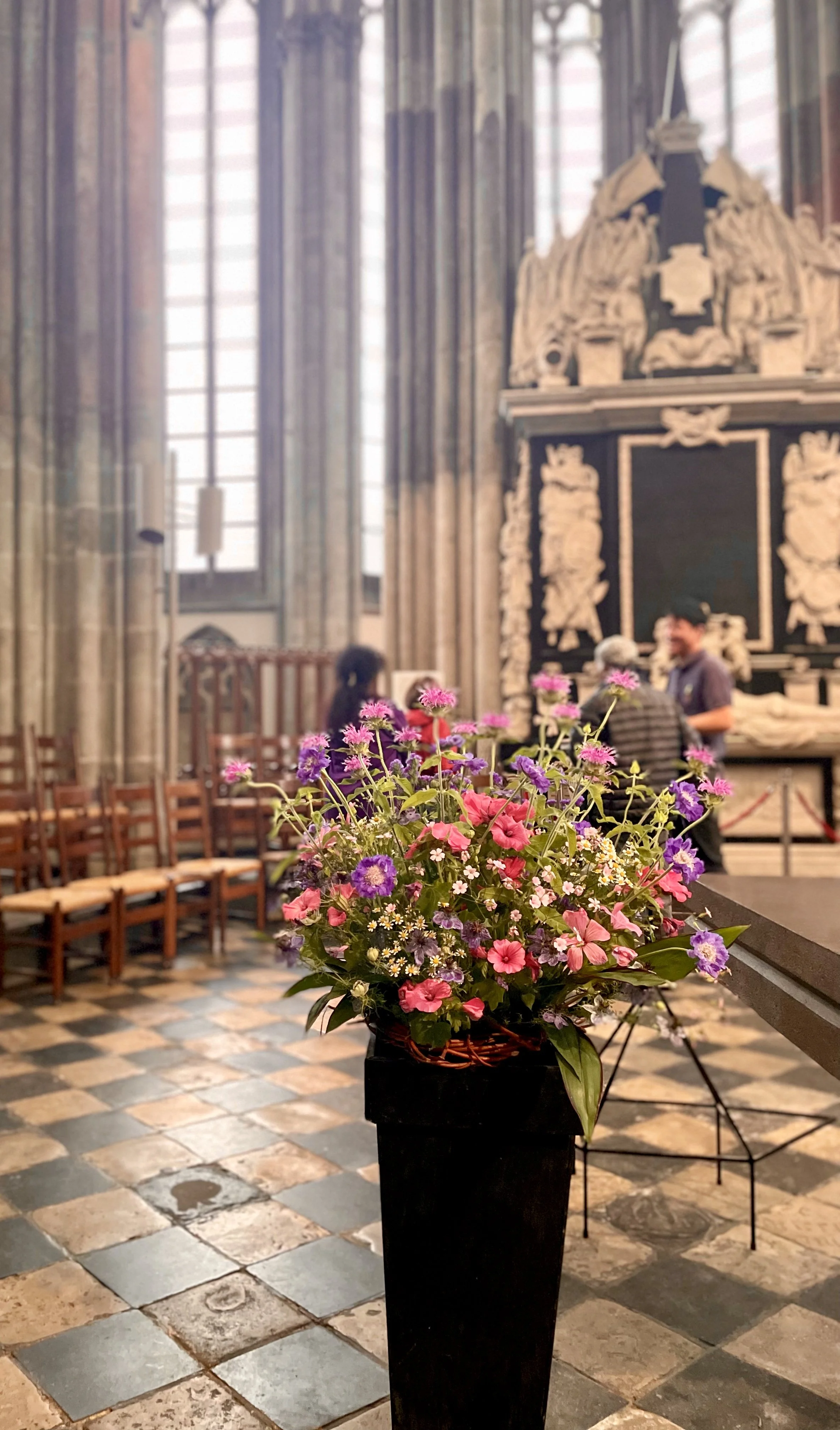 A colorful arrangement of flowers at the Domkerk in Utrecht displays beautiful, natural contrast to the neutral stone interior.