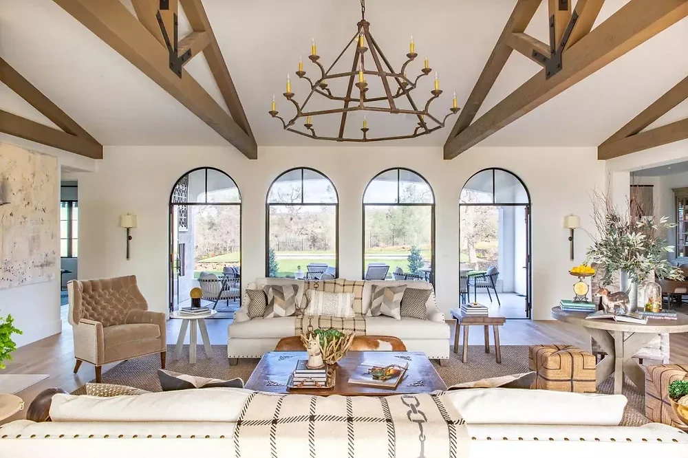 Palm Beach coastal chic living room with arched windows and fireplace