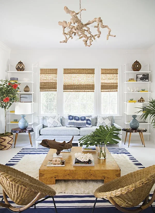 Coastal living room with rattan chairs and striped rug