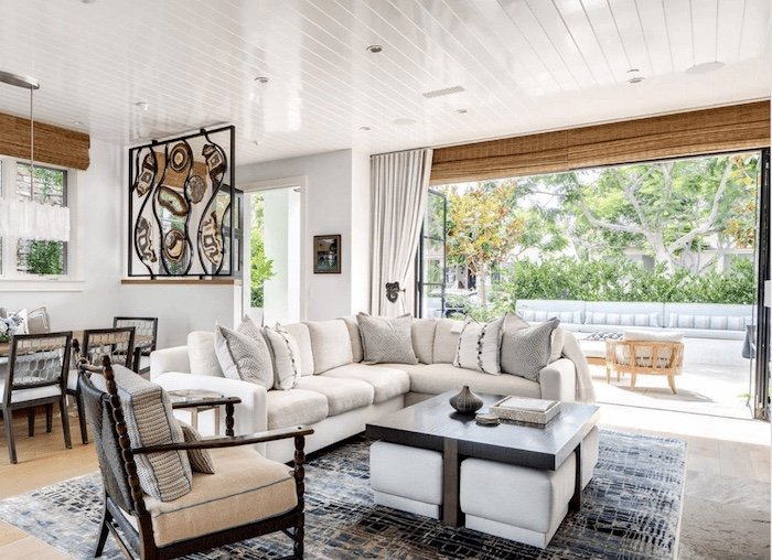 Many types of wood, bamboo, stone and other natural finishes add texture and depth to this great room that easily opens the back outdoor living space.