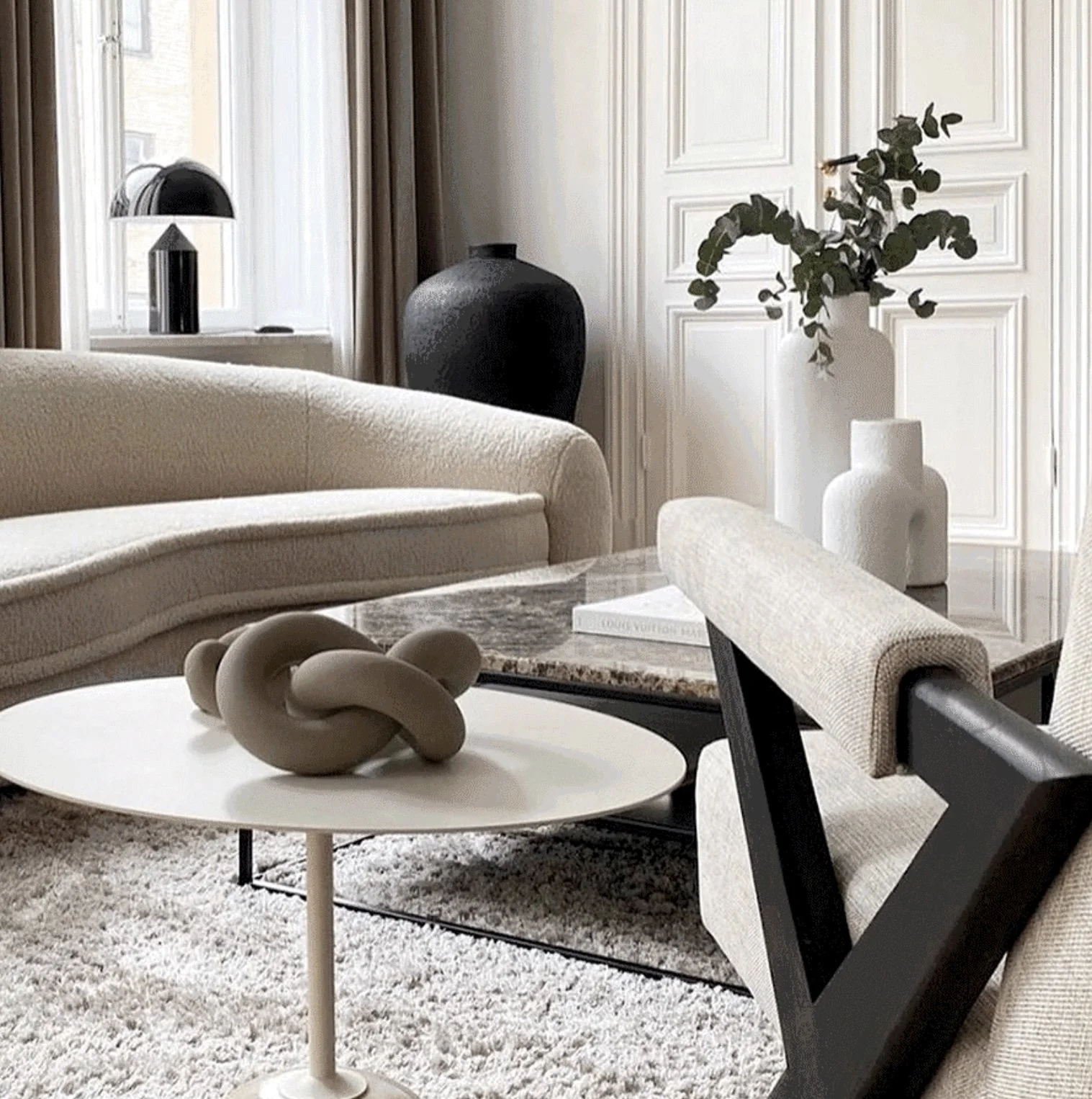 This living space is styled with Parisian classic modern design, with traditional moldings on the doors.