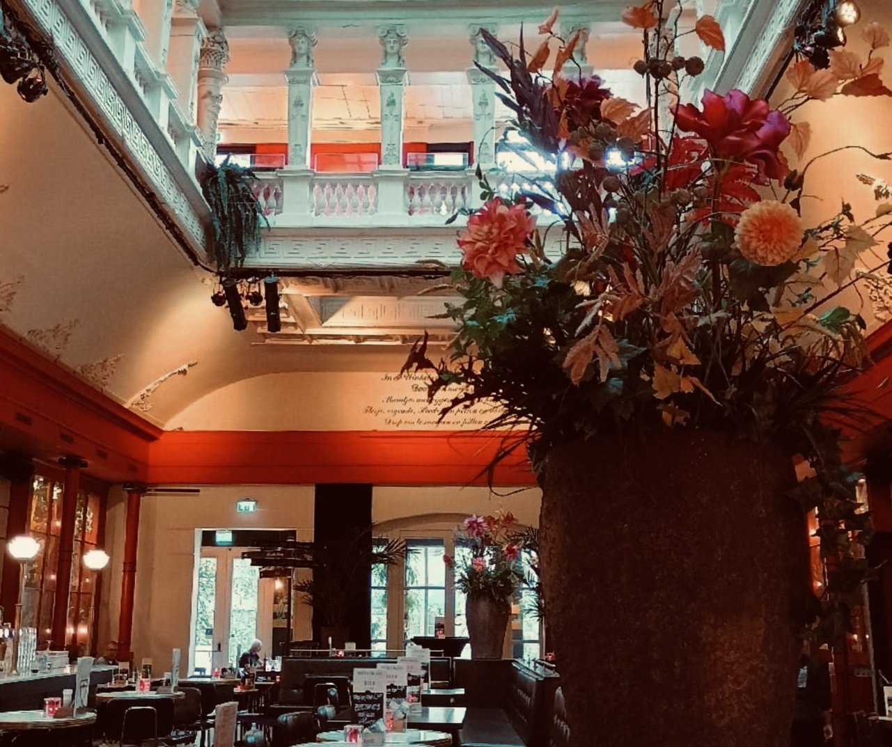 A large Dutch style floral in WInkel van Sinkel restaurant, with the columns above topped with female busts.