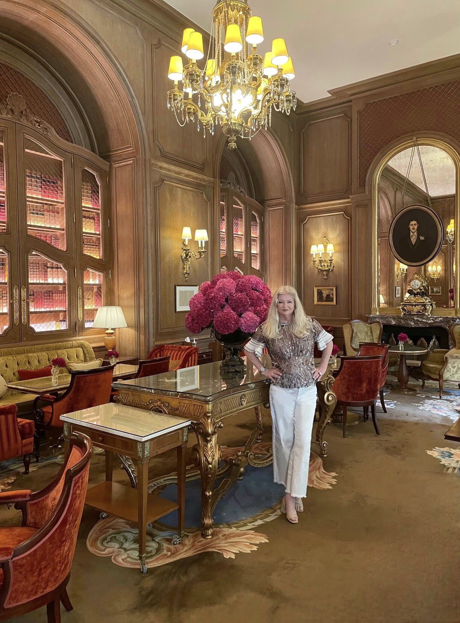 Denise Jadd, lead interior designer standing in the Paris Ritz Salon Proust.