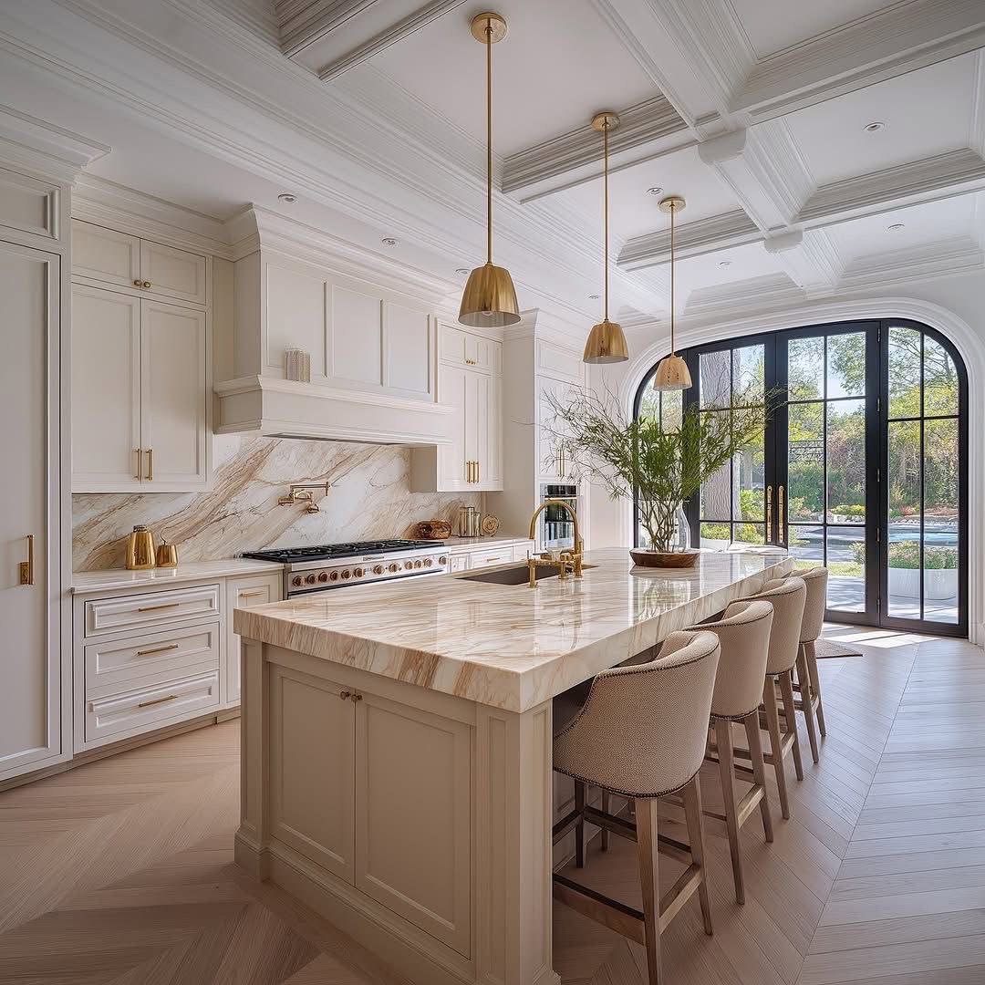 A Palm Beach kitchen, classic in design with two tone wood, in vanilla and honey, classic moulding on ceilings with chevron wood floors, exemplifies our timeless design philosophy.