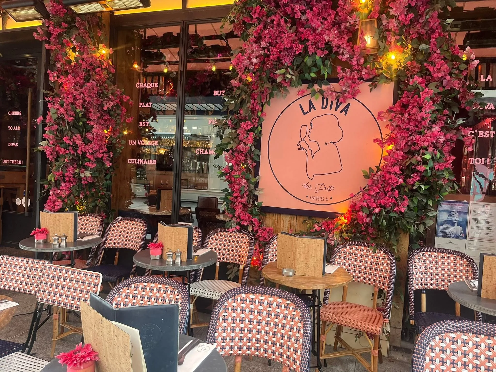 Café La Diva patio in Paris, with its pretty pink flowers and chairs.