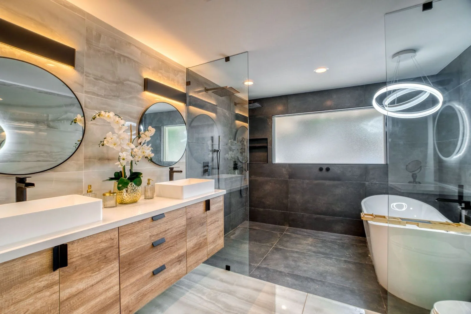 Modern luxury Palm Beach bathroom with floating vanity, double sinks, and glass shower