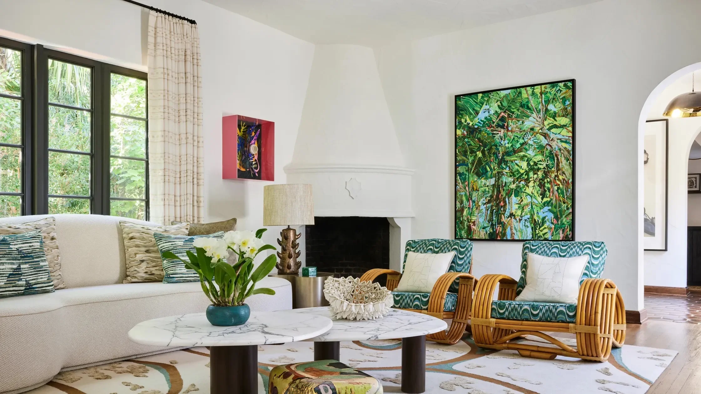 Bright Palm Beach coastal living room with neutral sofa and colorful art.