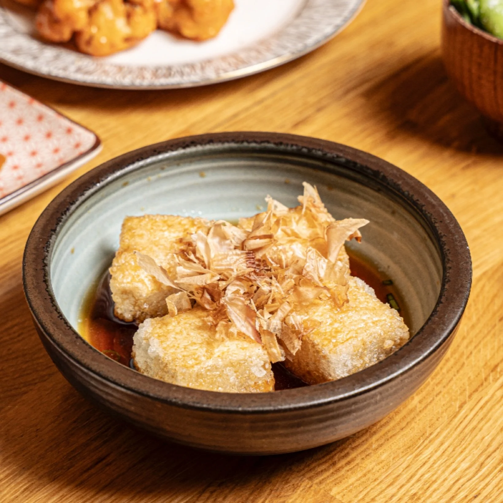 Agedashi Tofu 🍲✨ Lightly fried tofu served in savory tempura dressing, topped with dried bonito, ginger, daikon, and scallions. Comfort and flavor in every bite at Izakaya Osen.

#IzakayaOsen #AgedashiTofu