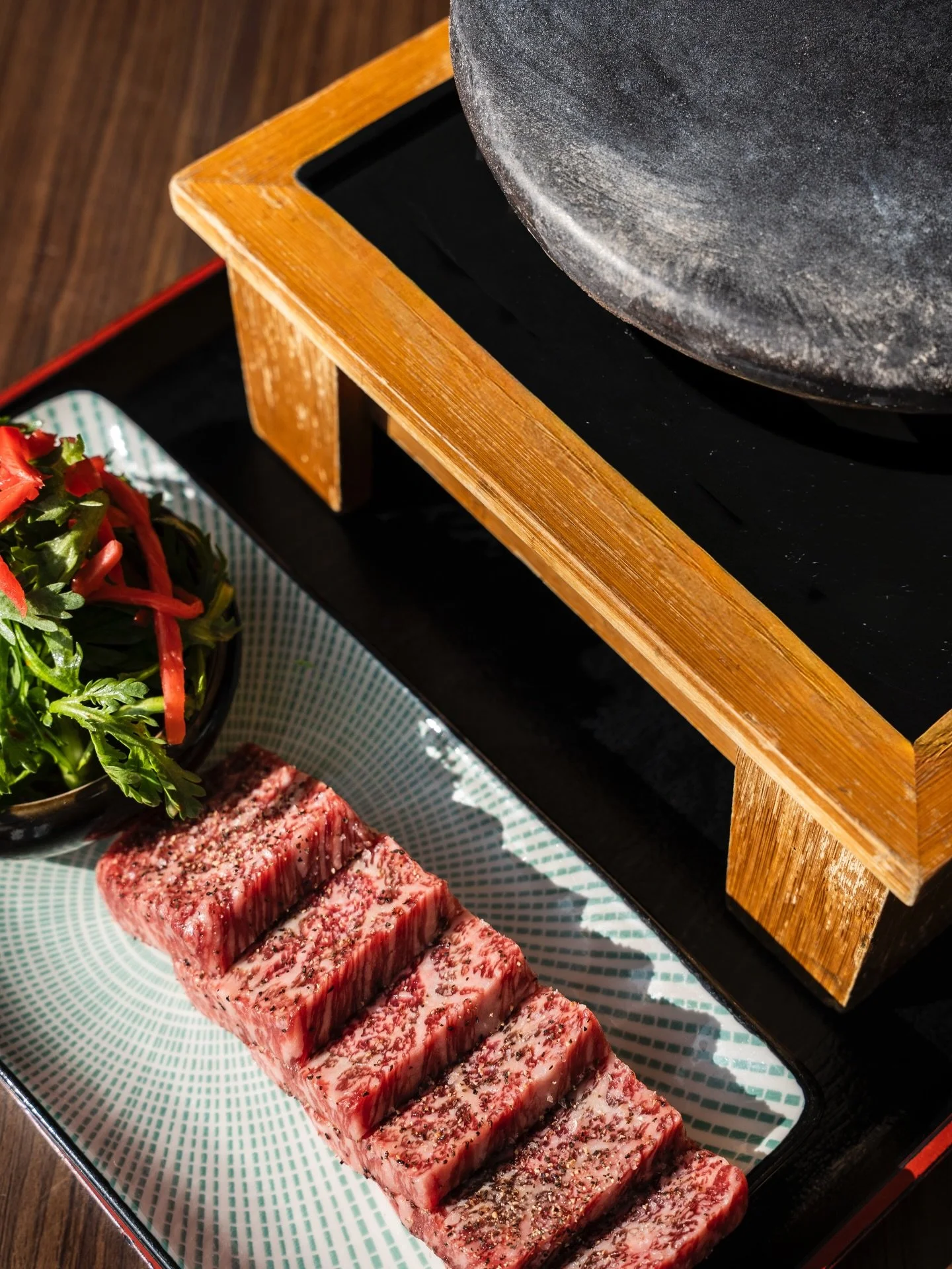 Premium Japanese A5 Wagyu, grilled on a sizzling hot stone at your table.

Deep marbling. Intense umami. Silky finish.