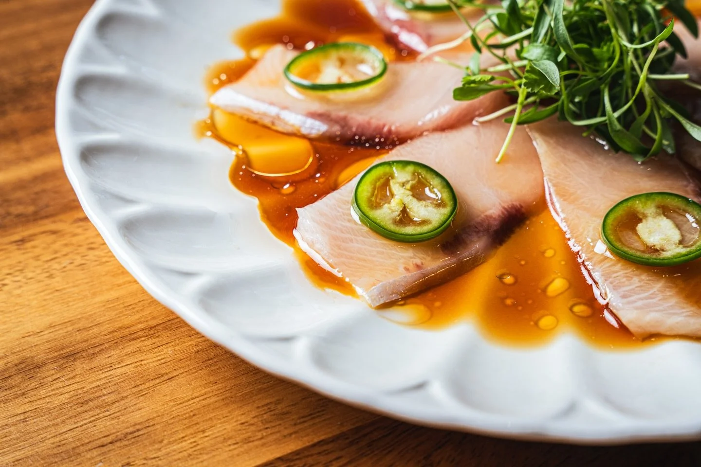 🌶️✨ Yellowtail Jalape&ntilde;o 🌶️✨

7 pieces of melt-in-your-mouth yellowtail sashimi, topped with fresh serrano, cilantro, ponzu, garlic, and a drizzle of olive oil. Light, zesty, and dangerously addictive