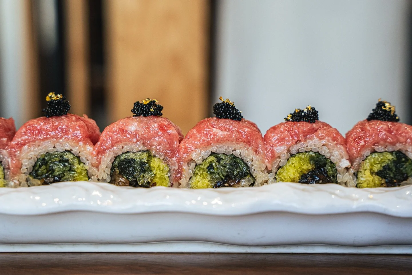 🐟 Toro Roll ✨

Chopped toro with fresh chive and an assortment of pickled bites including wasabi leaf, daikon, kanpyo, and kelp, finished with black tobiko and a touch of gold flakes. Rich, vibrant, and elegantly bold 🖤