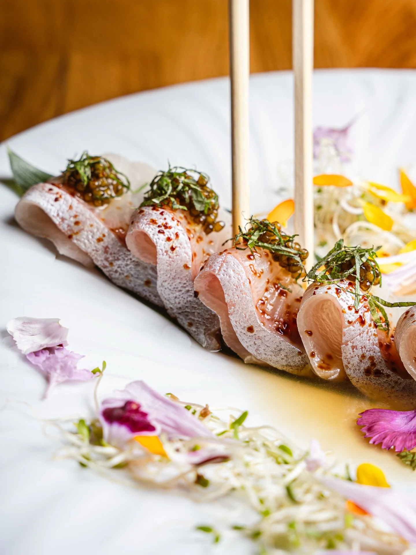 Yuzu-kissed kanpachi, layered with umami and a citrusy bite 🍋✨ 7 slices of amberjack with caviar, ponzu, yuzu kosho, and shiso &mdash; clean, bright, and dangerously addictive.

#IzakayaNights #YuzuEverything #Kanpachi