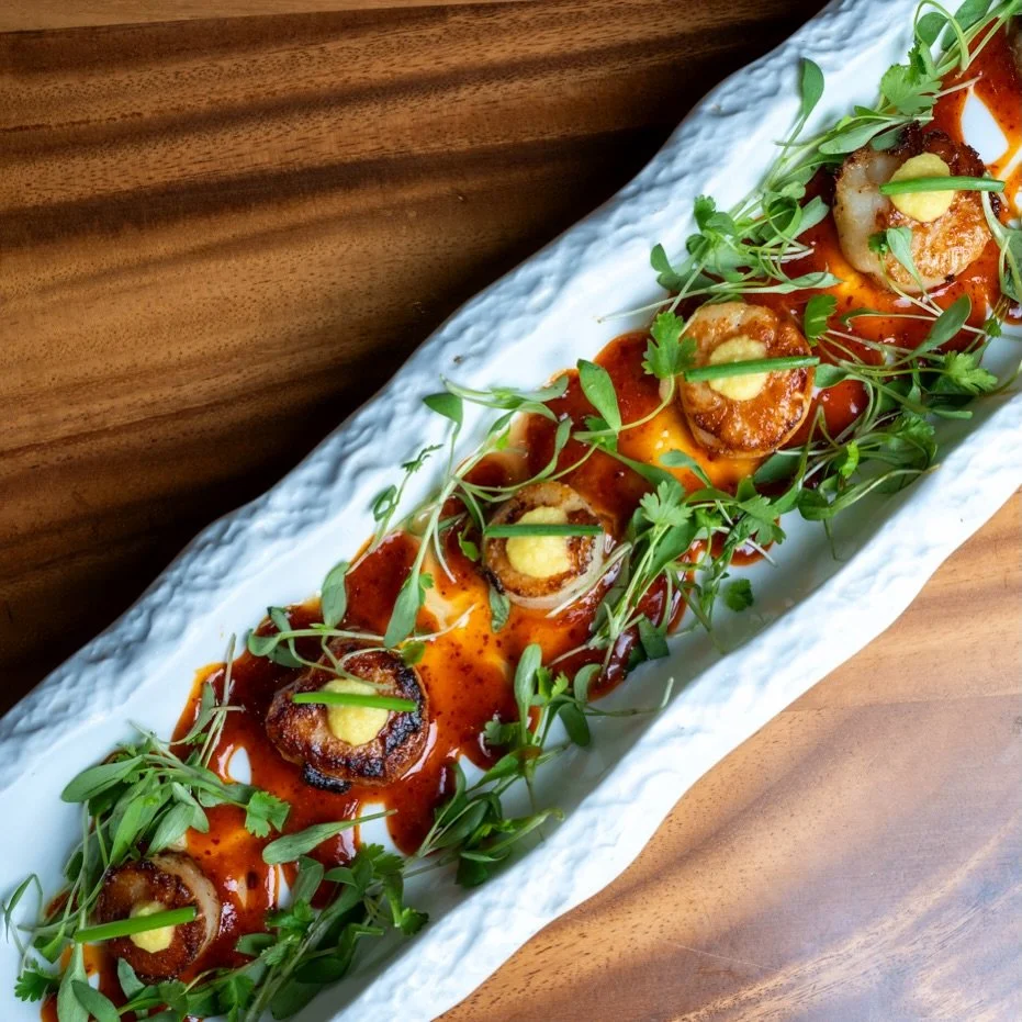 Rich, buttery, and perfectly seared 🔥
Our Seared Scallop features butter-saut&eacute;ed scallops with ginger paste and chives, finished with chili crisp oil and a touch of sweet chili dressing.

Bold heat meets delicate sweetness in every bite 🐚✨
