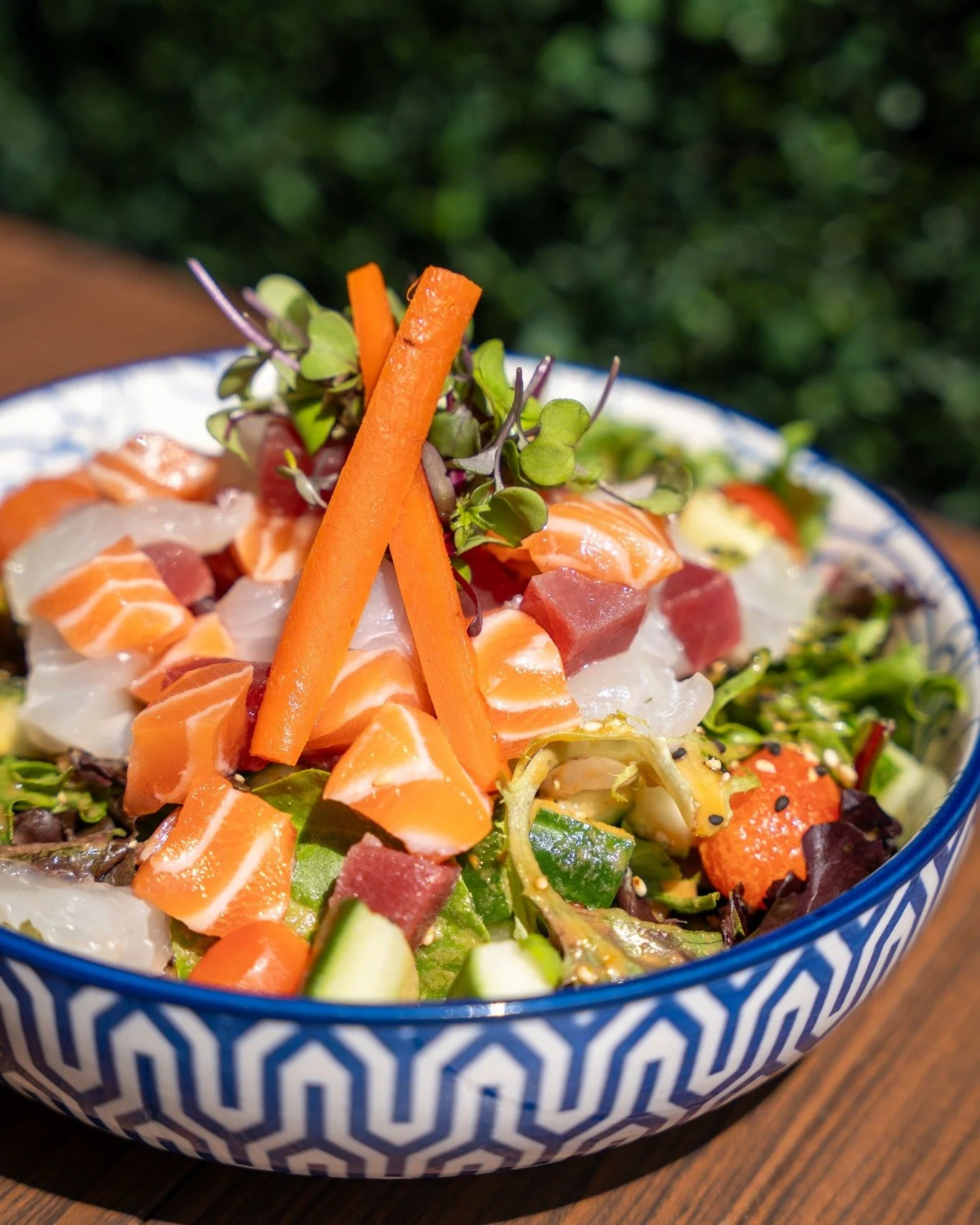 Fresh, vibrant, and packed with flavor. 
Our Sashimi Salad features assorted diced sashimi, crisp spring mix, cucumber, tomato, and burdock root, finished with furikake, ginger dressing, and olive oil.

A lighter way to enjoy your seafood cravings.

