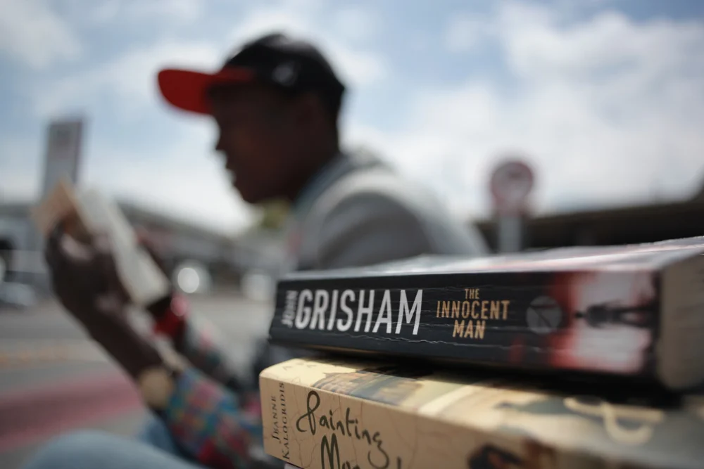 Philani, 24, makes a living selling books on a Johannesburg street corner, South Africa (Photo: Tebogo Malope)