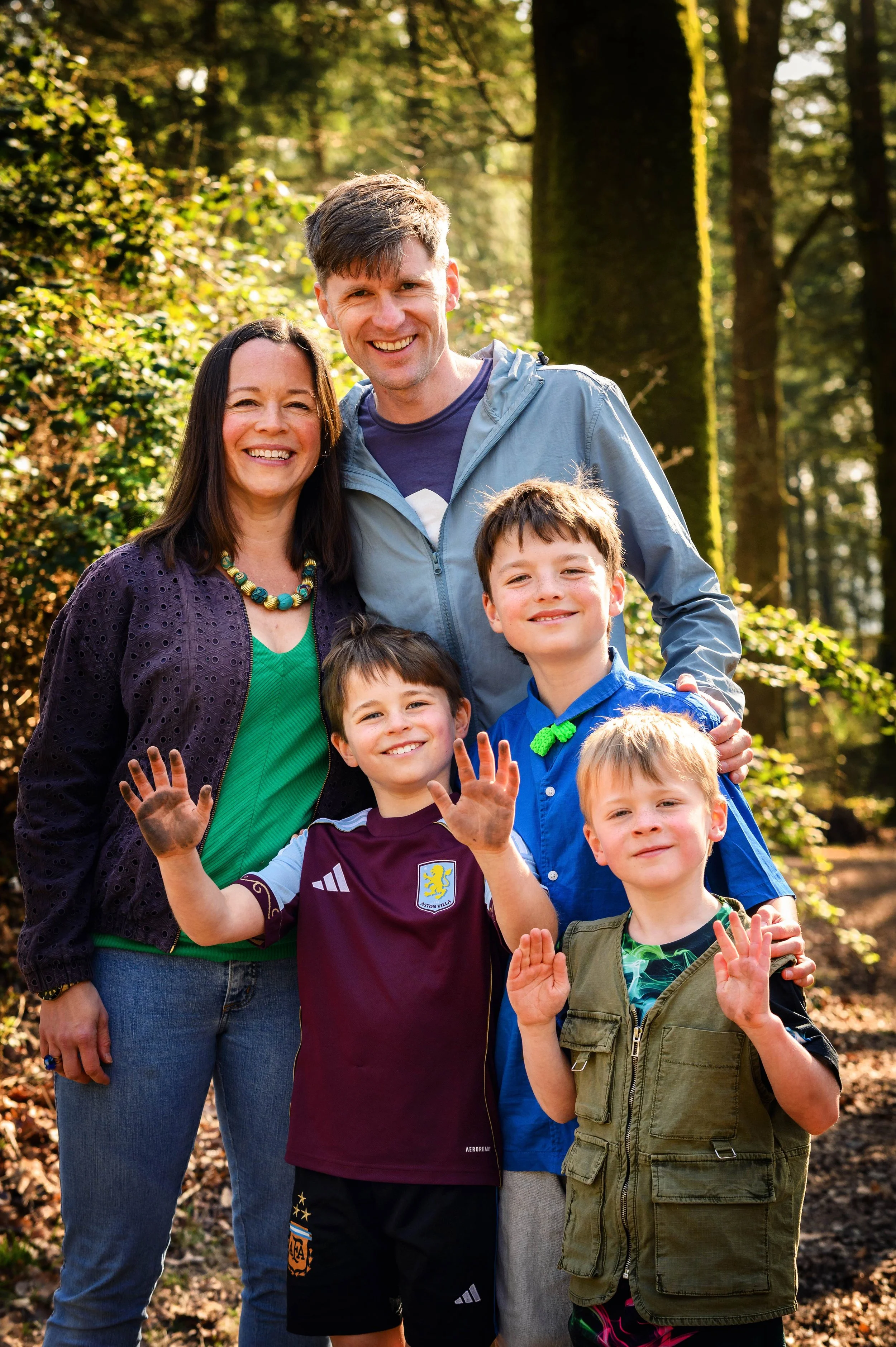 brothers showing off their muddy hands during a relaxed family photoshoot near Exeter in Devon