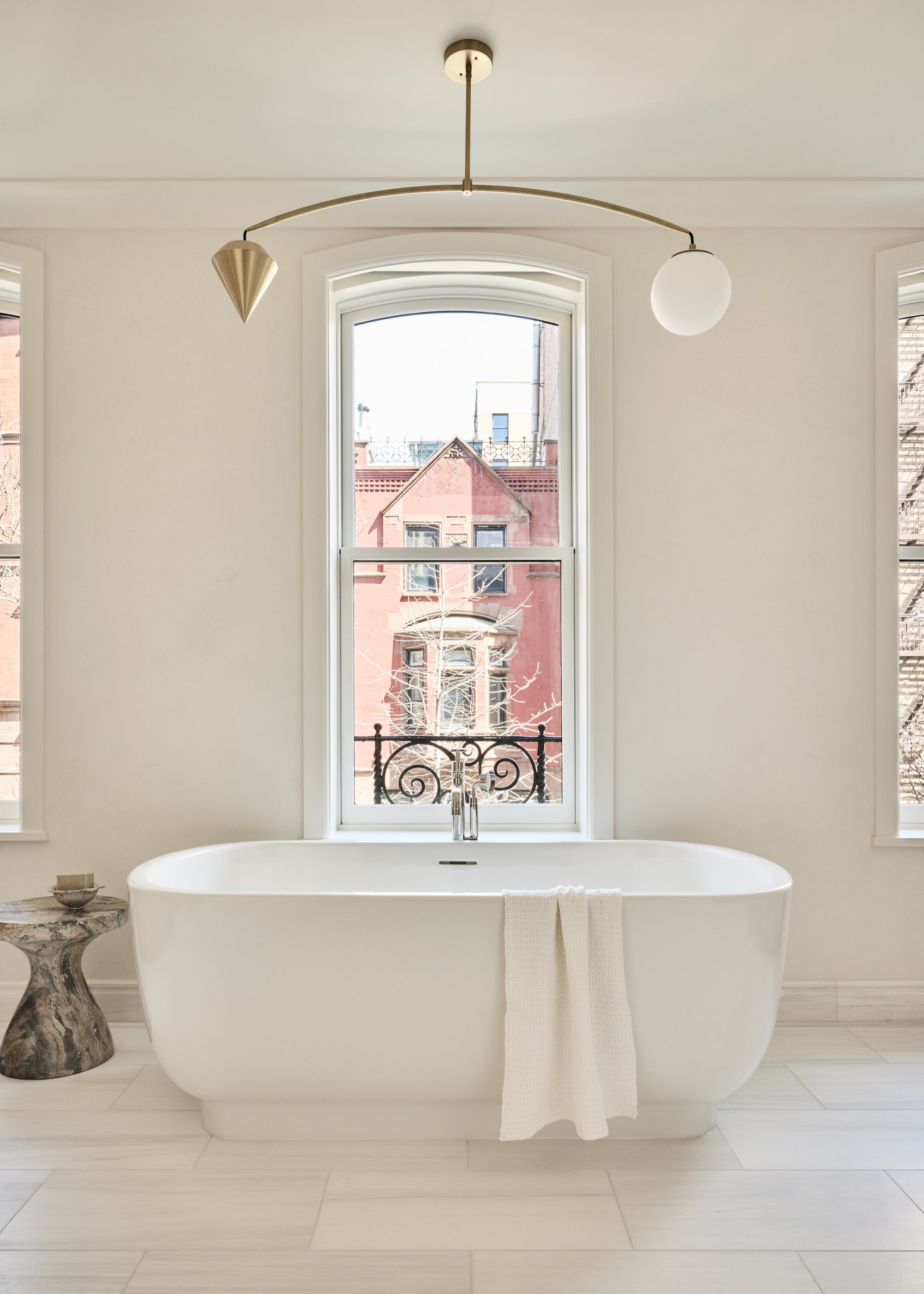 24. Uptown Townhouse by Chango & Co - Primary Bathroom Tub with Stool.jpg