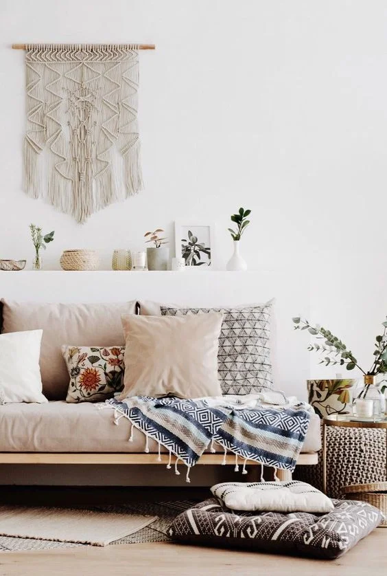 Sofa with wall hanging and blush pink cushions .jpg