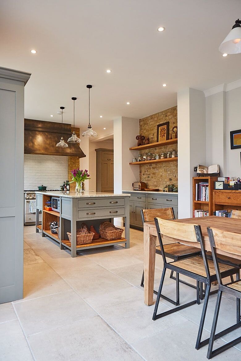 Celebrating classic country cabinetry for the modern home, the Weybridge kitchen project combines the dusky olive tones of Little Green’s Grey Moss with natural wood shelving and rustic exposed brickwork_ Painted cabinets are paired with.jpeg