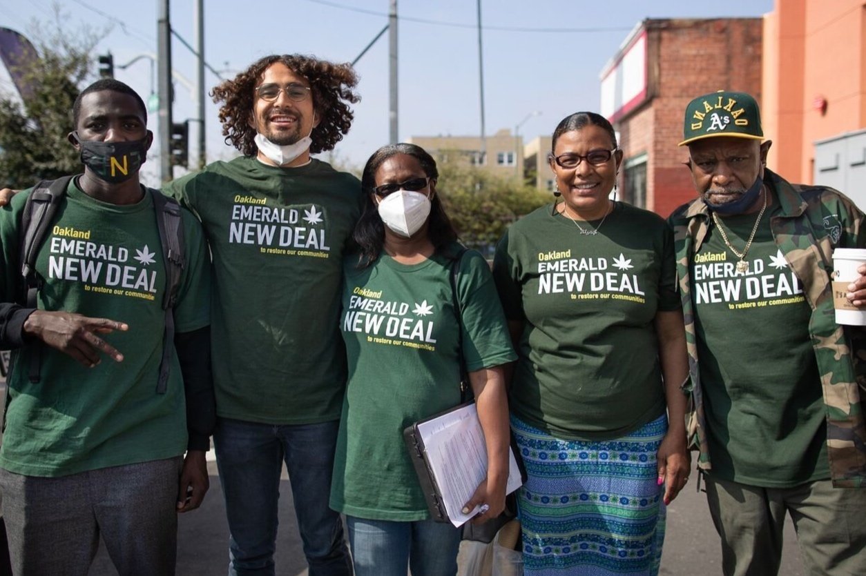  Emerald New Deal organizers door-knocking in East Oakland's seminary neighborhood. From right: Charles Reed, Gamila Abdelhalim, Shawna Norman, Ben Toney. Credit: Amir Aziz 