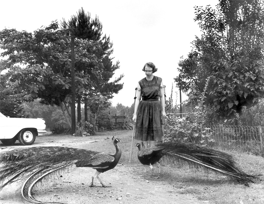 FLANNERY O’CONNOR IN THE DRIVEWAY AT ANDALUSIA, 1962. © JOE MCTYRE/ATLANTA CONSTITUTION.