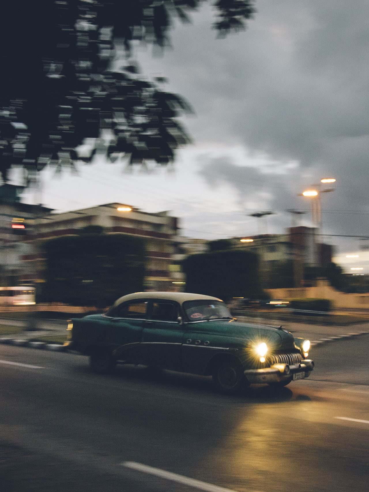 A Buick Roadmaster lumbers through the early evening.