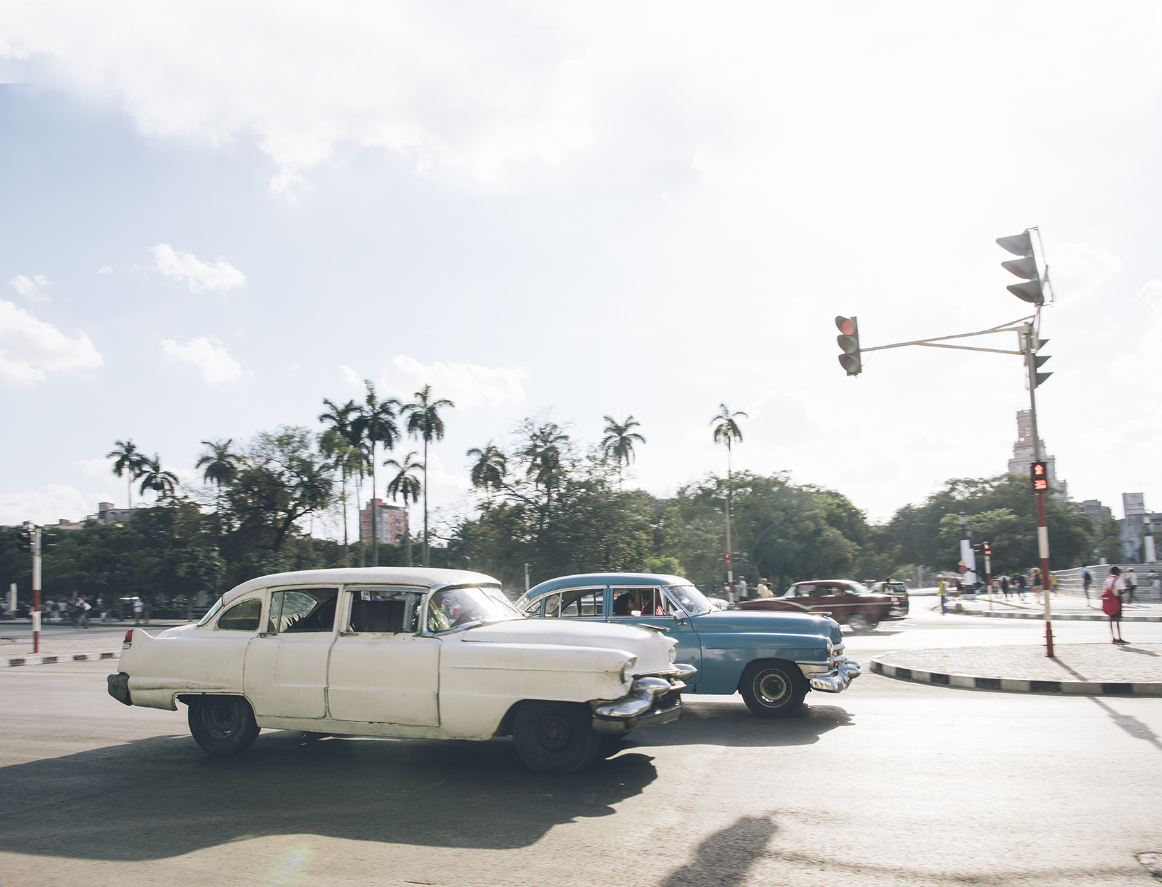  1950s Cadillacs rolling through suburban Havana. 