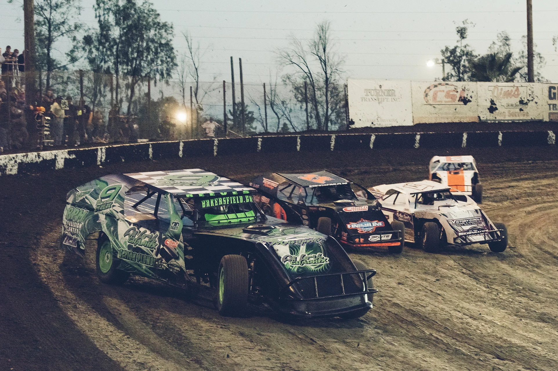 IMCA Modifieds accelerate out of turn two at Bakersfield.