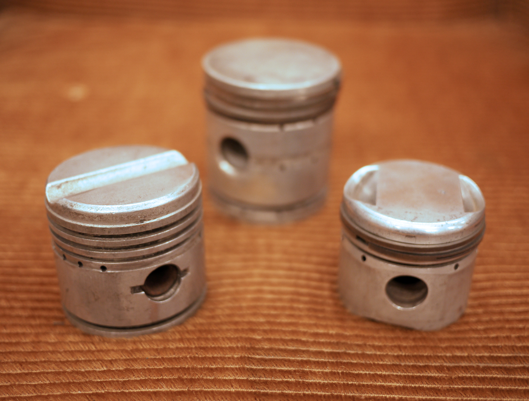 Fantastic Trio of pistons from three of the most prestigious cars ever made. Left Bugatti (note the flame groove in the top), middle Alfa 8c 2900, right Miller.