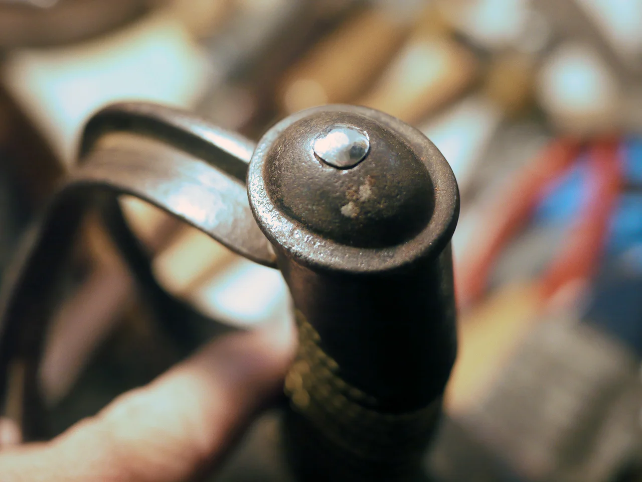 Close up of the tang. It has been peened over to fill the countersunk hole in the grip cap. This locks the sword together. But you can only do it once. It would have to be drilled out to disassemble again.