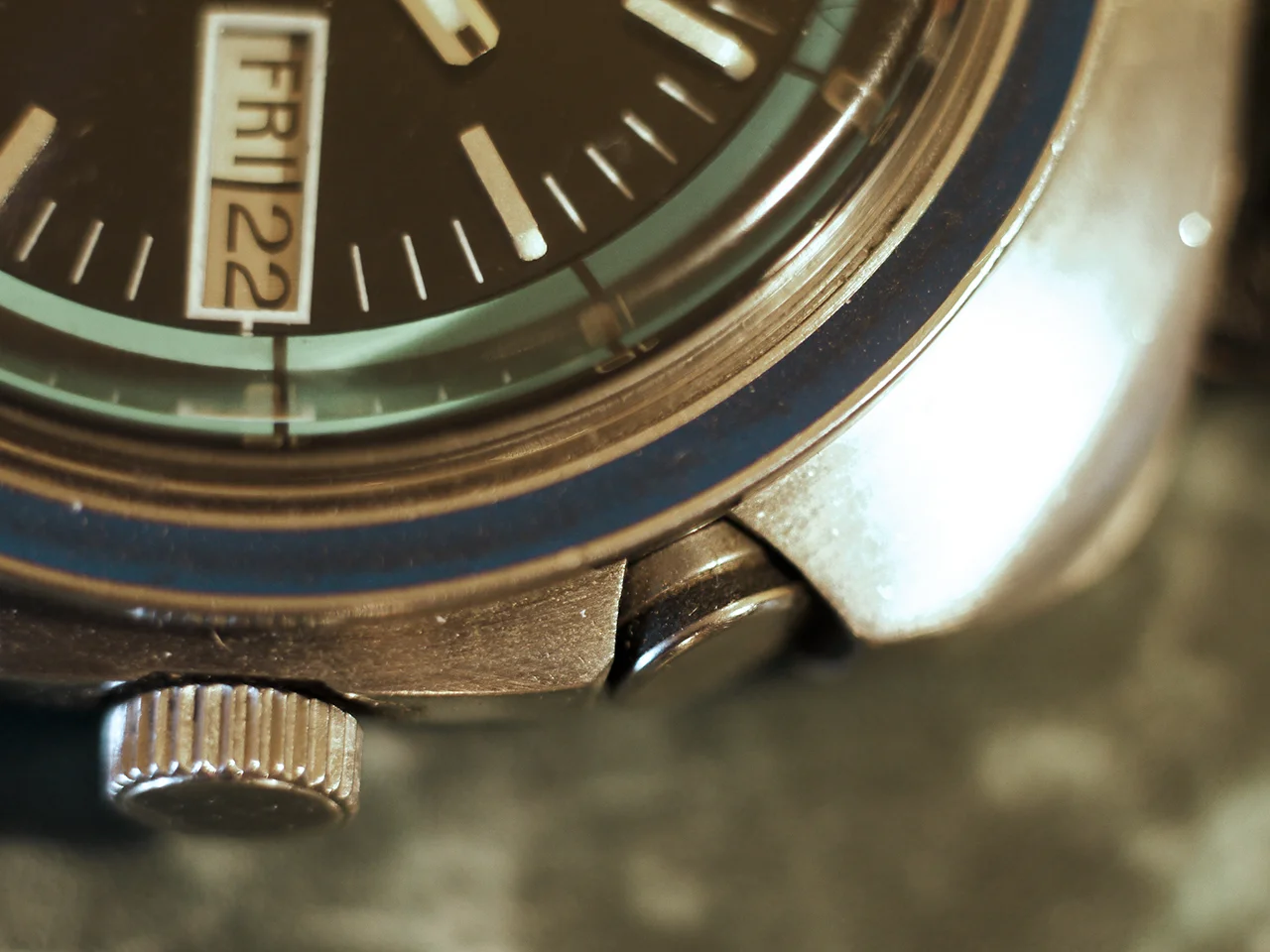 The crown wheel sets the time and also winds and sets the alarm. The watch is automatic but the spring for the alarm hammer must be wound. The upper knob turns the alarm on and off.