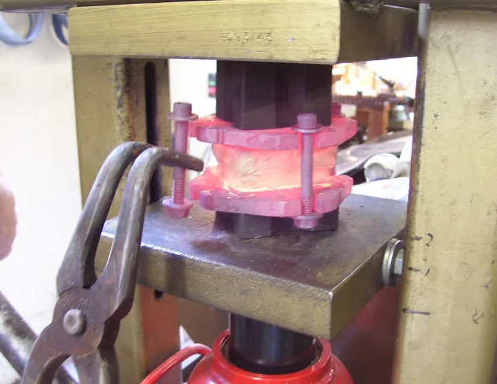 Fig. 4: This billet will be compressed about 3mm before the bolts are removed. The steel blocks give clearance for the bolts.