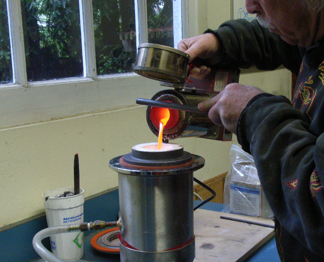 Fig. 7: Electric melting furnace casting an ingot in a vacuum chamber.