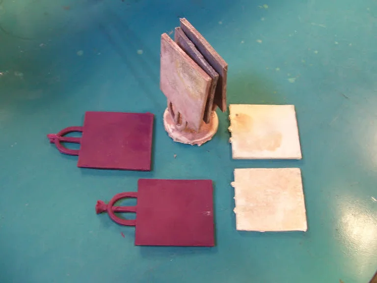 Fig. 8: Injection mold waxes on the left, poured casting at the top, clipped cast ingots on the right.