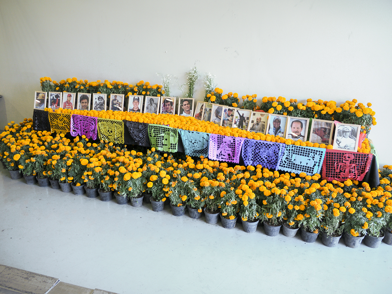 Dia de Muertos alter in the FIA pit stall commemorating racing drivers who have died. 