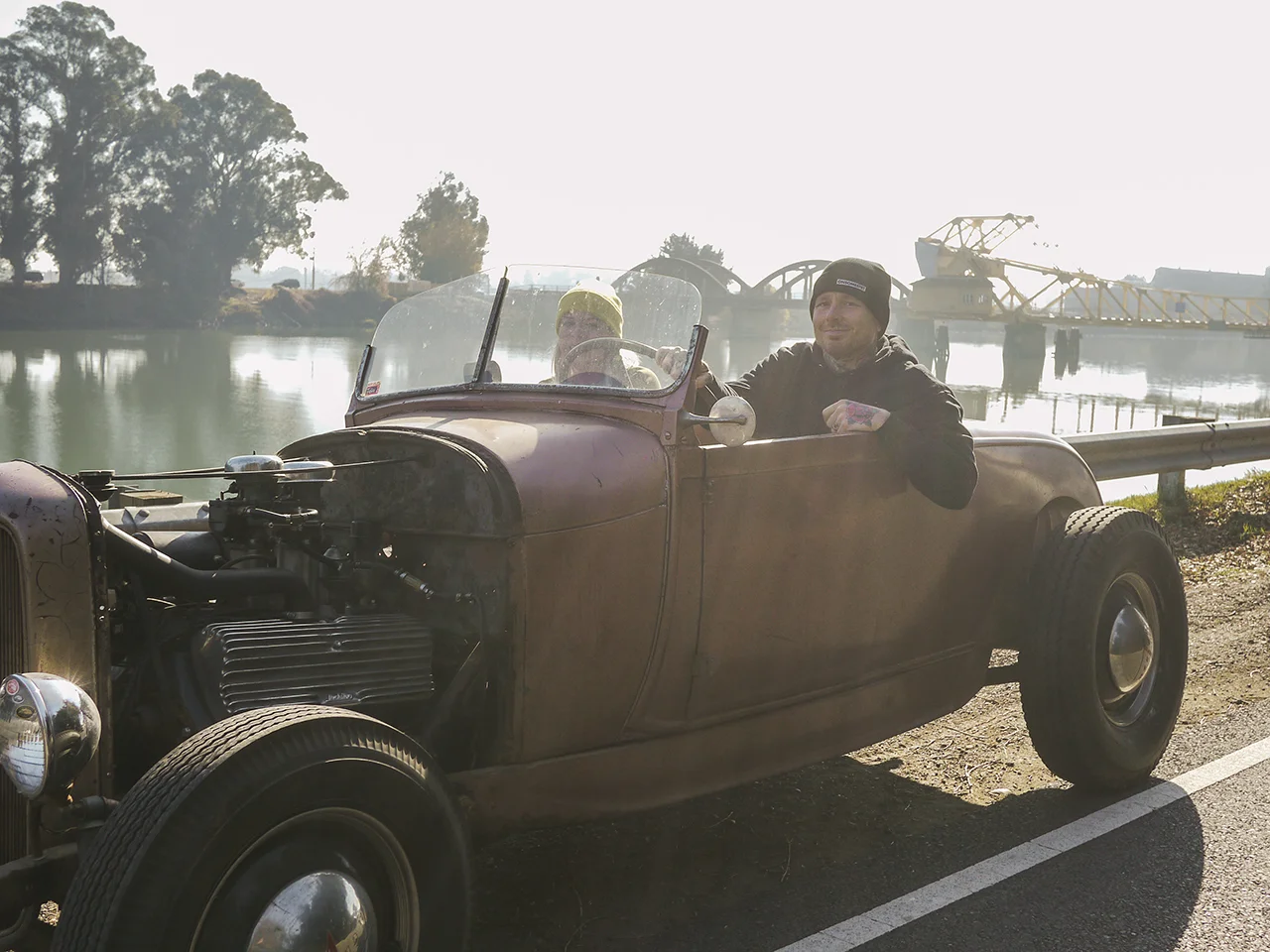 Paul Garland and his wife Rachael driving one of the cars from Bruce Woodward's collection.