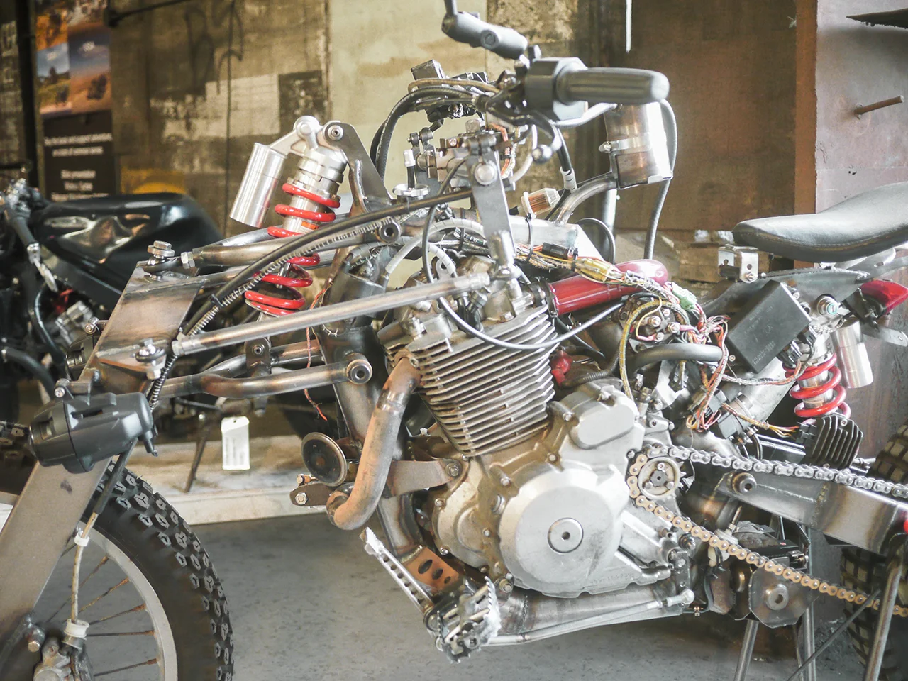 Closeup of the Suzuki DR650 mill and the Hossack front suspension .