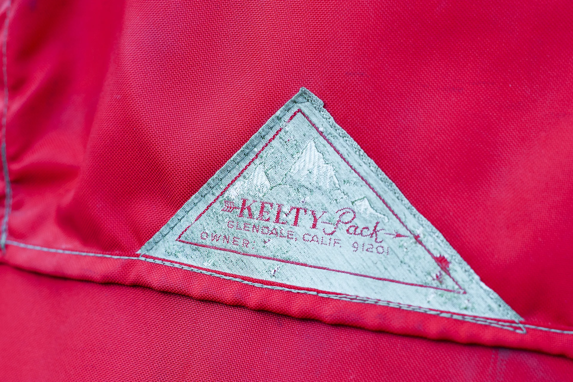 The famous Kelty label on my grandfather Roscoe Masonheimer's pack. We think this pack was purchased in the late 1950s. The label is the earliest version with the realistic embroidered mountains and the Glendale, Calif., address. The second version has the Sun Valley address and the third version has a cubist rendering of the mountains in the background. Note the quirky use of the zip code on the label. The arrow ads a feeling of motion and action. These pack bags were hand-sewn.