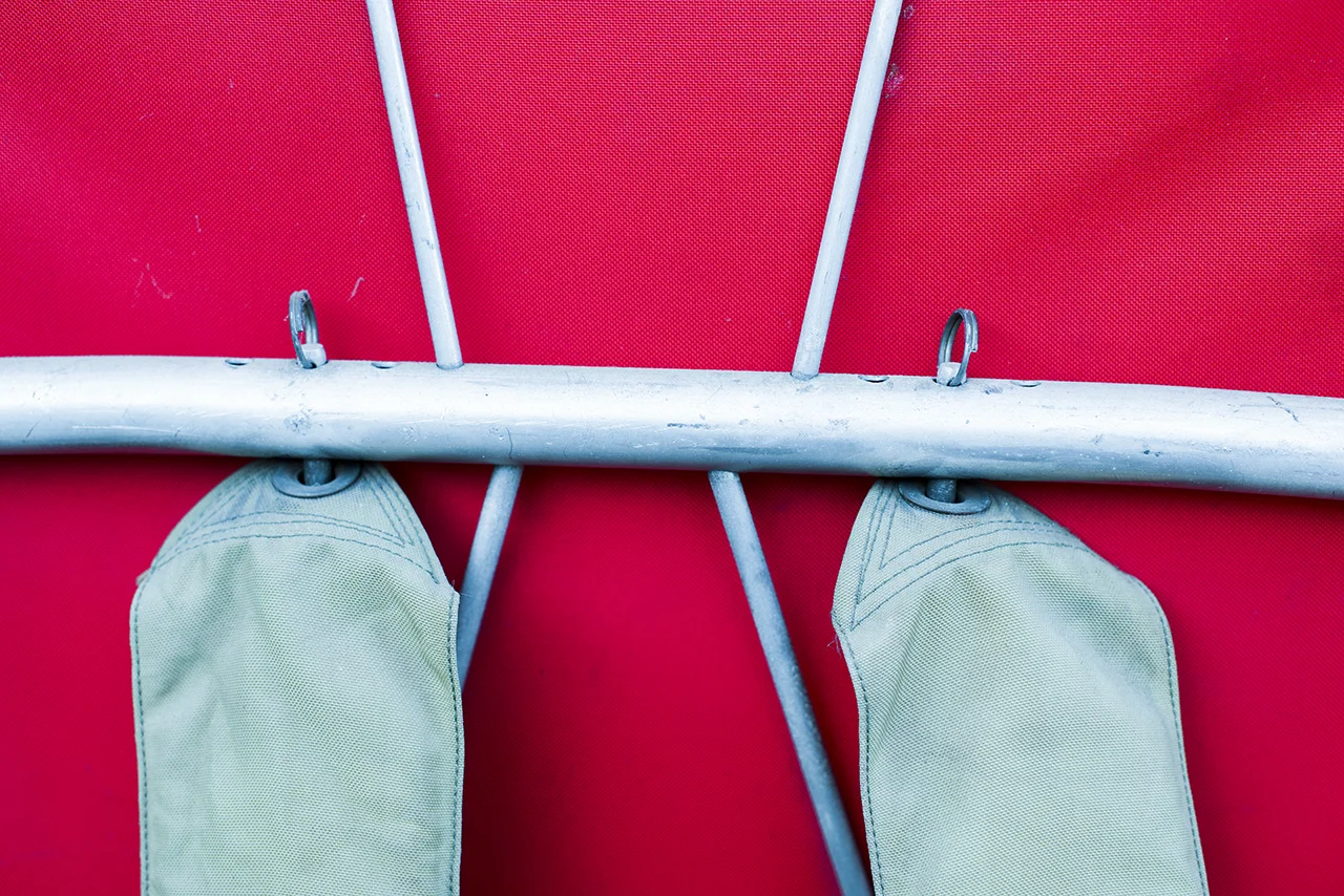 Clevis pins were used as a method of connecting the straps to the frame as well as attaching the bag to the frame.. They are lightweight and strong as well as being easy to use. The cross bar is drilled to offer three positions for the straps to mount, thus accommodating different body shapes.