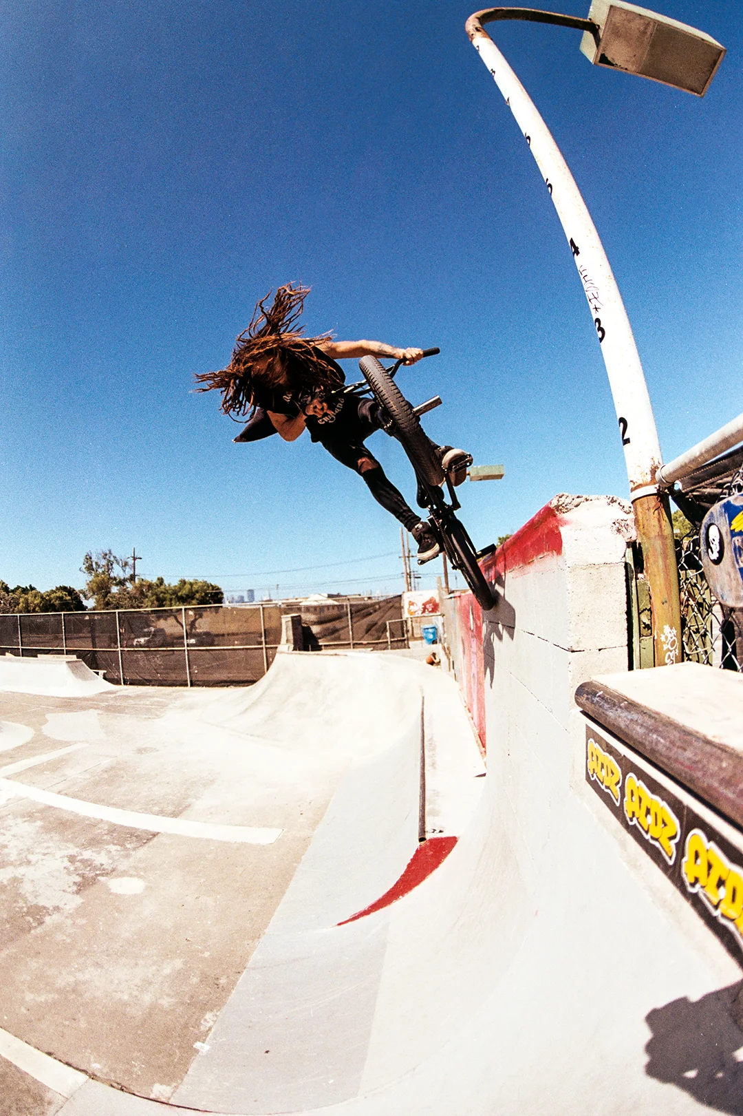 This photo is of Washington native Johnny Dempsey. It’s always exciting to me when a new guy comes to town with years of riding under his belt because everything they do is a surprise to me. Johnny is one of the gnarliest dudes our scene has at the moment and this 12-foot-tall ice pick stall on a DIY vert wall is proof. This is at the Treasure Island DIY park which has some of the best homemade ramps I've ever seen. Taken with the Nikon FM2 and the 16mm.