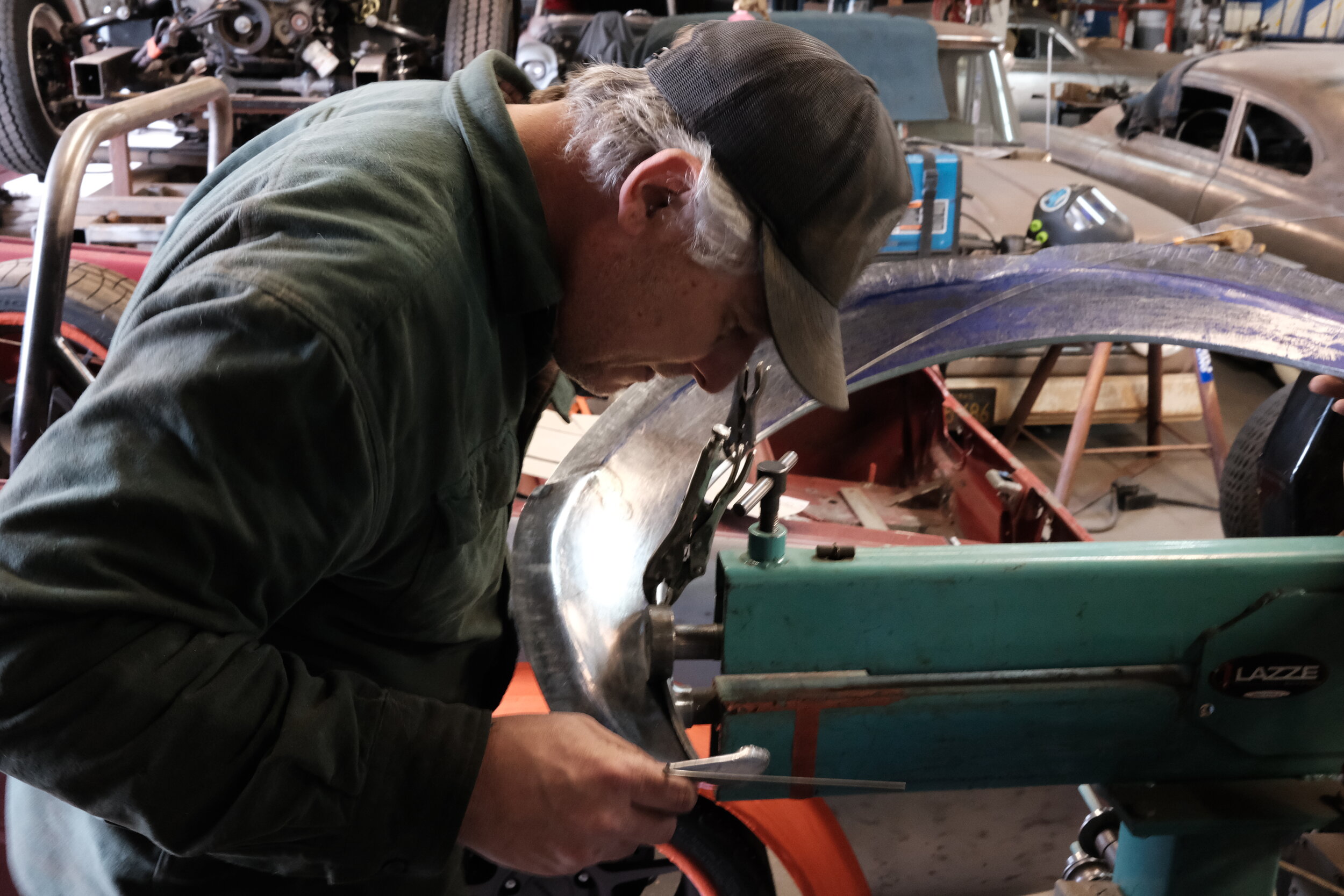  Andy Leverenz uses a bead roller to fold the edge of flare over a wire. The flares will go on a convertible Mustang. 
