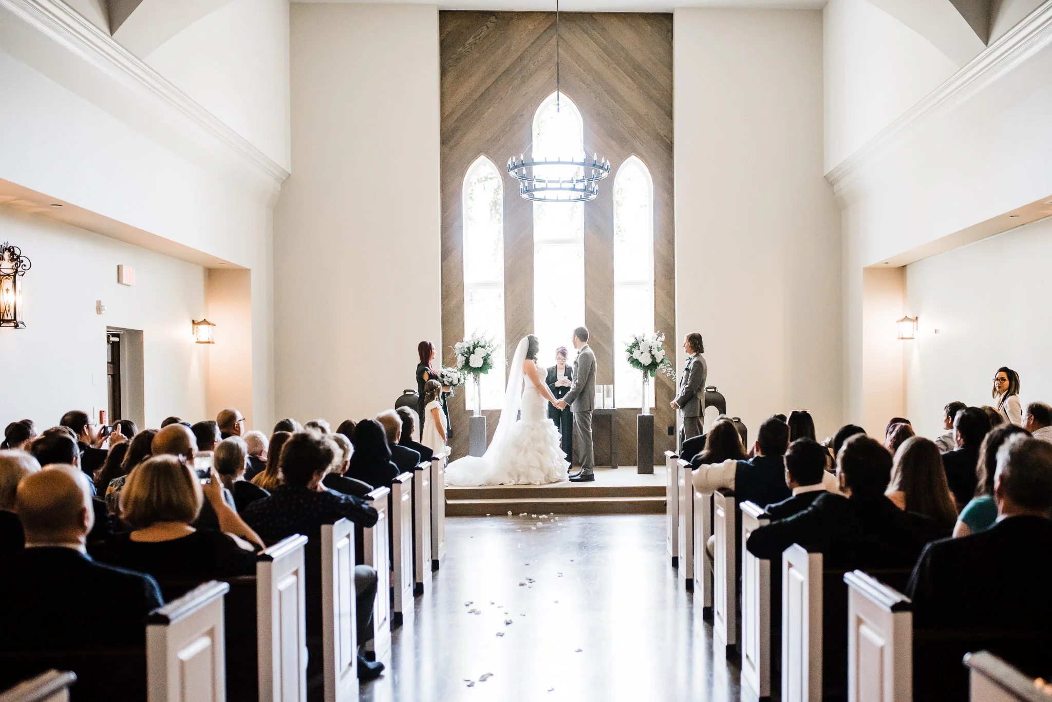 Wide shot of the bride and groom as they read their vows 