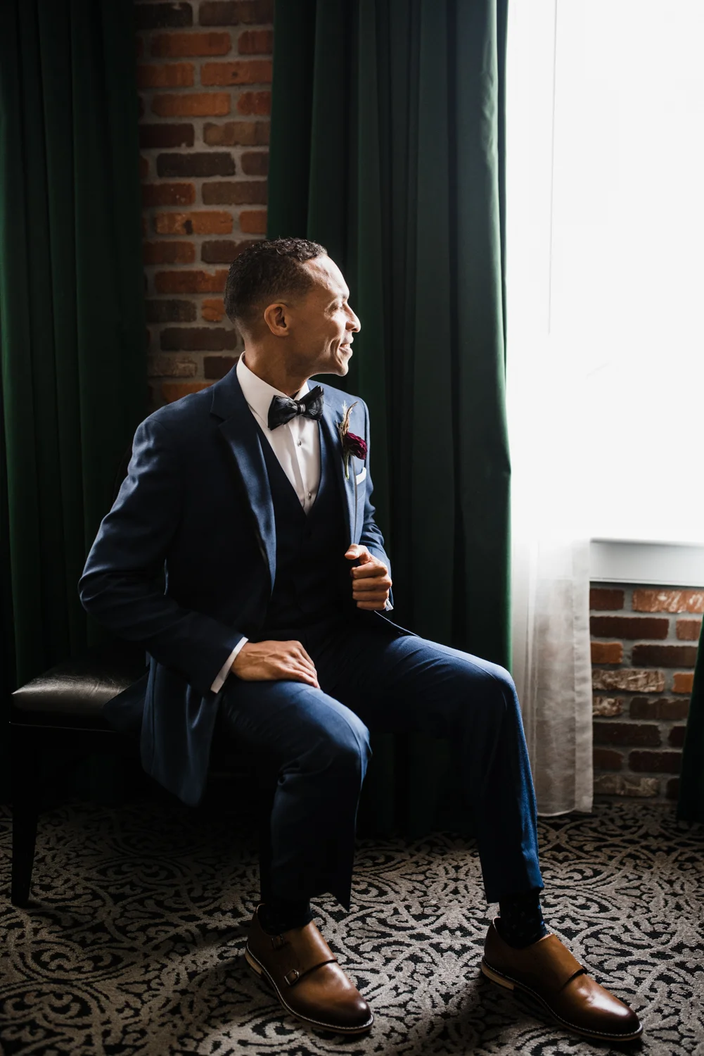 Groom posing in suit in New Orleans