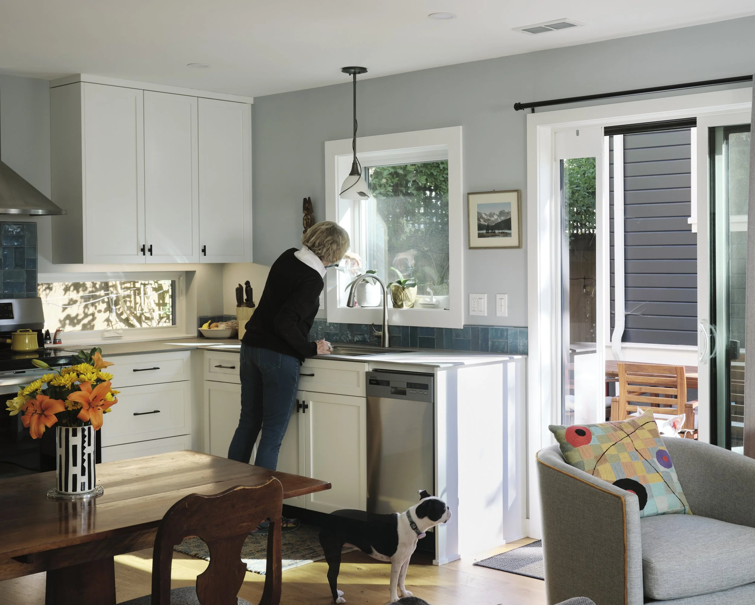 Bright kitchen with main residence seen through window