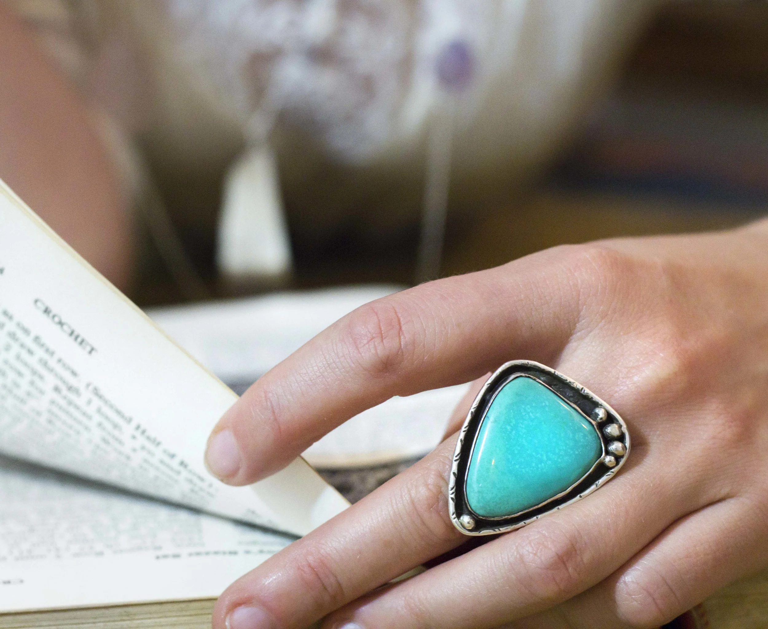 prodlibrary-close up of turq ring turning page.jpg