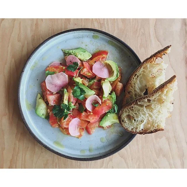 #DESAYUNODECAMPEONES strikes again! Heirloom tomatoes, aguacate, pickled radishes, cilantro and sumac vinagreta con tostadas ! UNTIL WE RUN OUT 🏃&zwj;♀️ Add an egg and anchovies for extra power